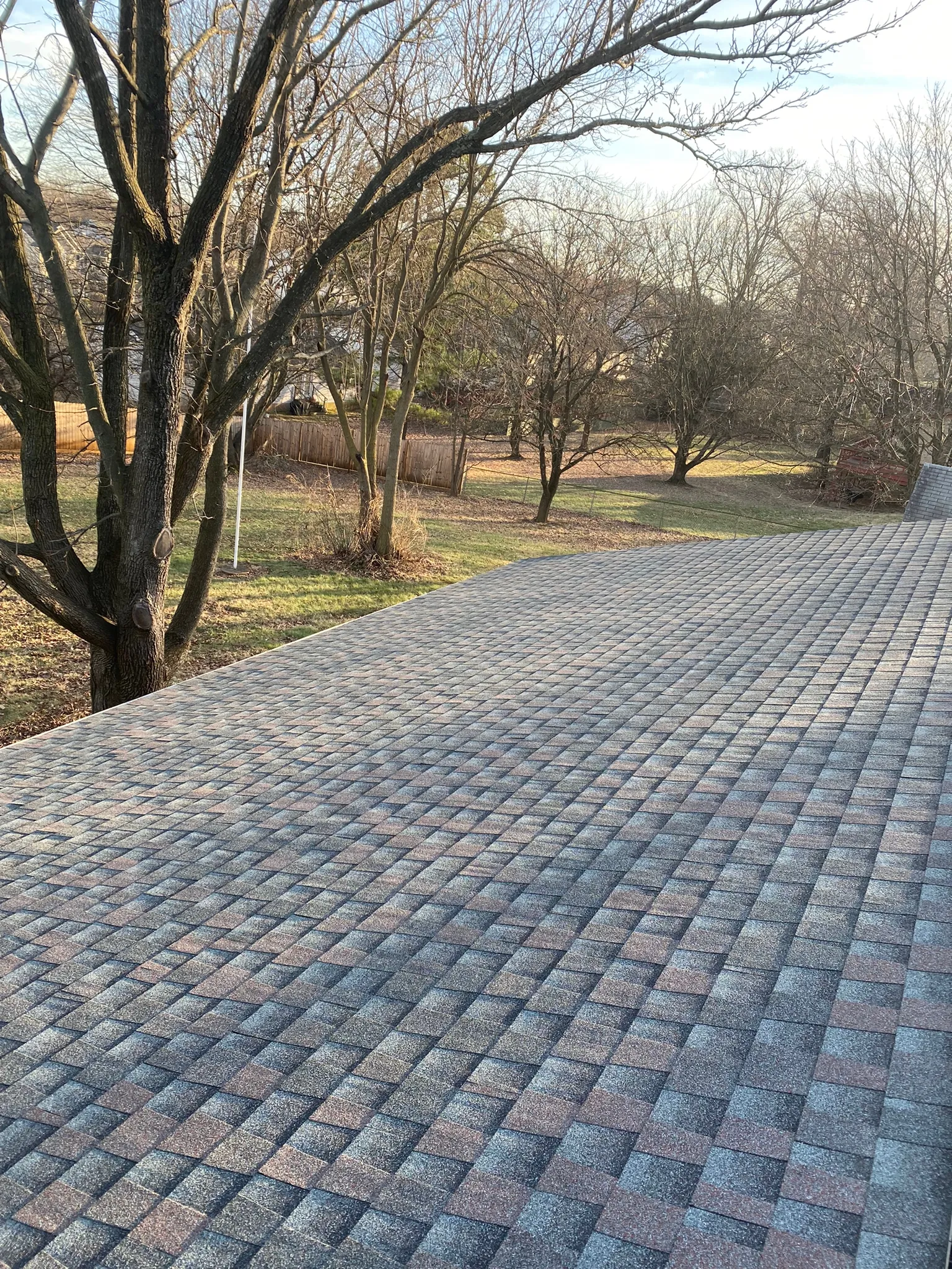 Close view of asphalt shingles and ridge cap