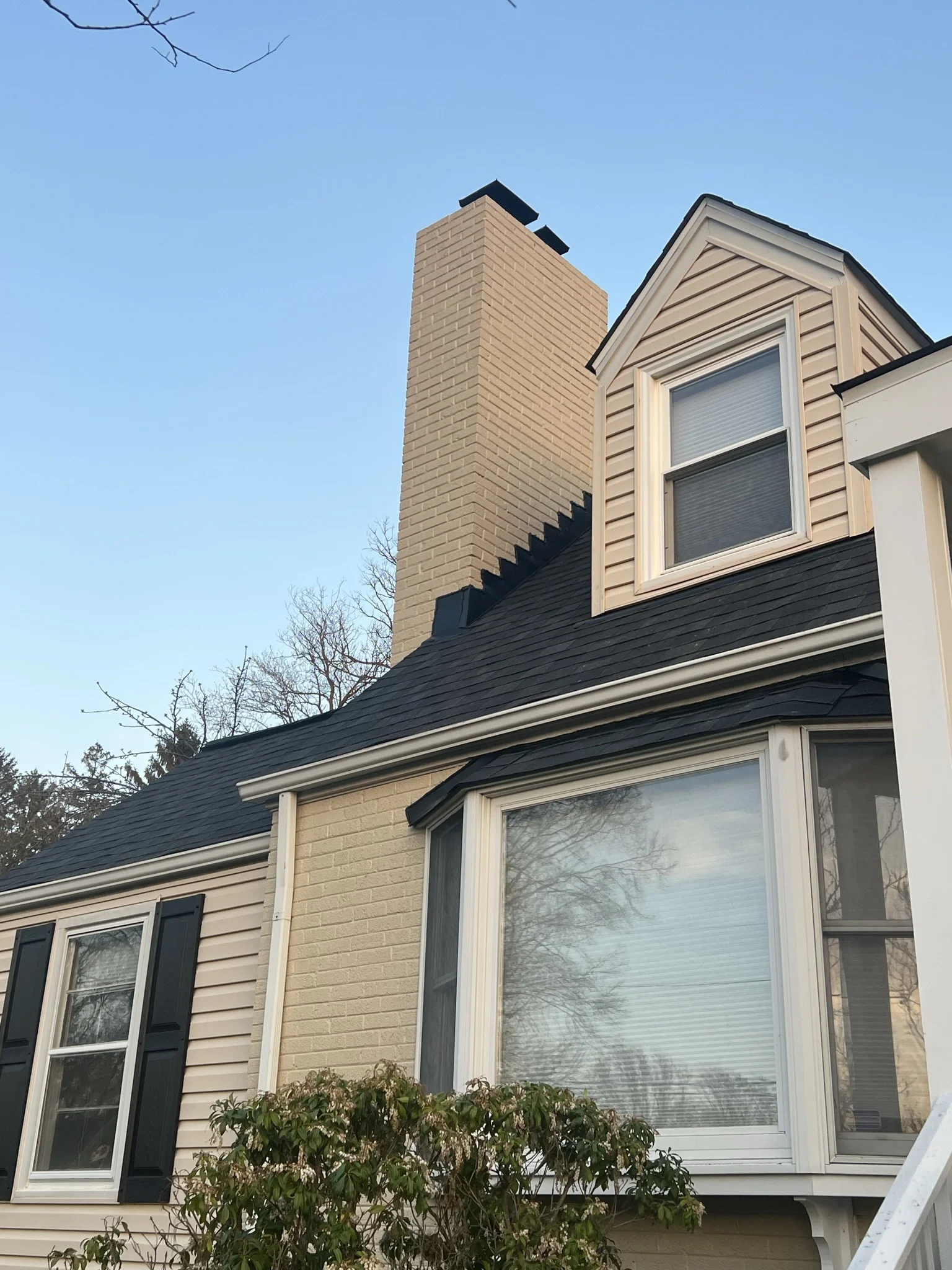 Dark brown architectural shingles on a colonial home