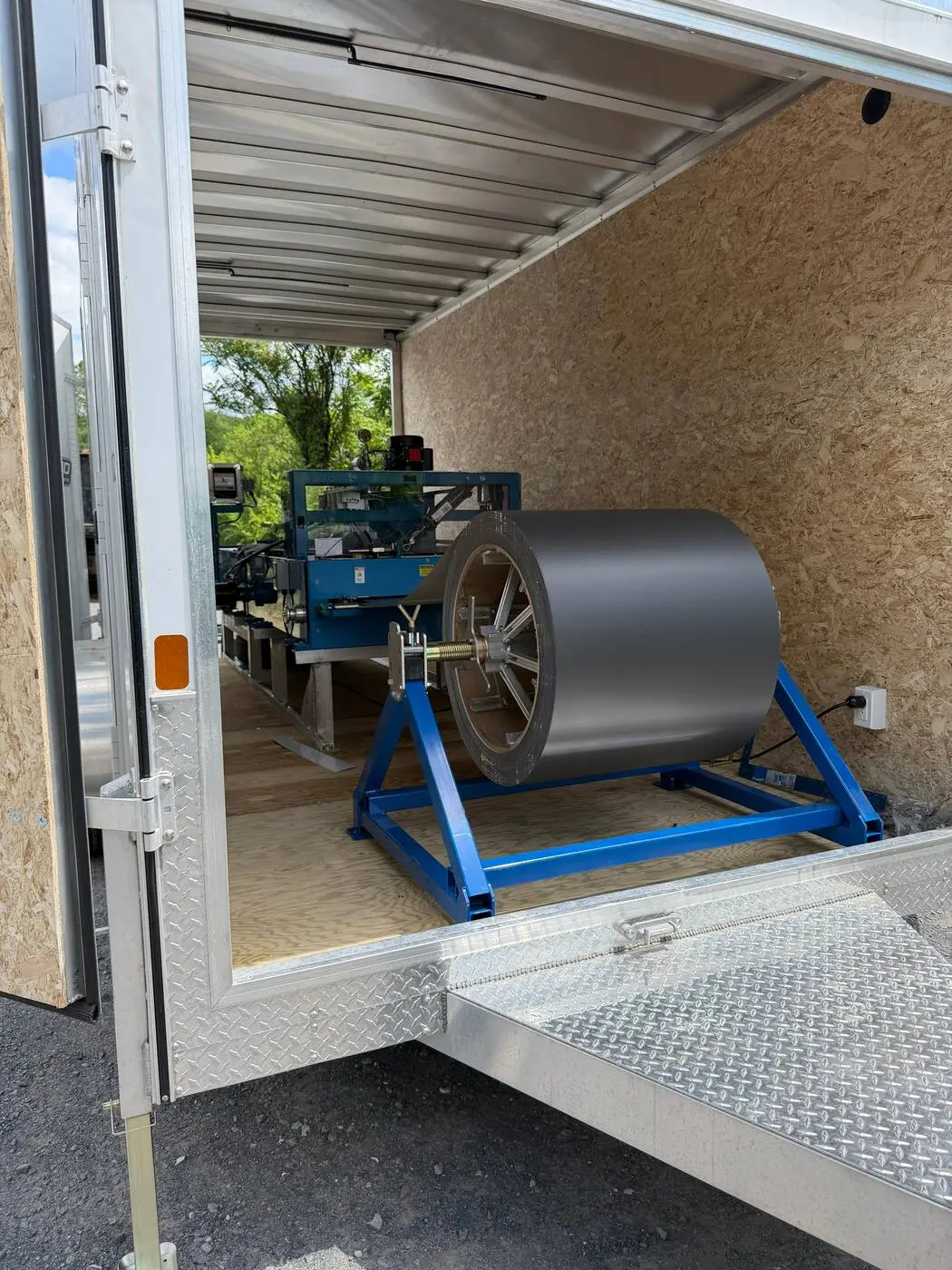 Coil of charcoal metal stock loaded for standing seam panel forming
