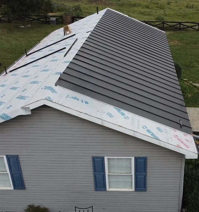 Metal roof installation showing formed panels alongside underlayment in Northern Virginia