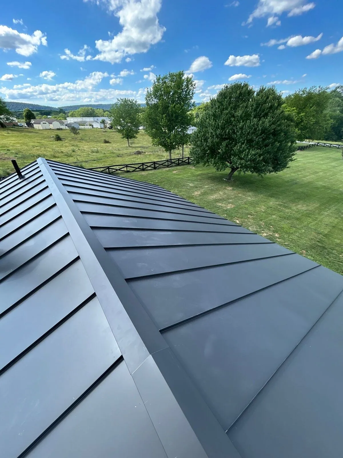 Finished standing seam metal roof with clean ridge line in Northern Virginia